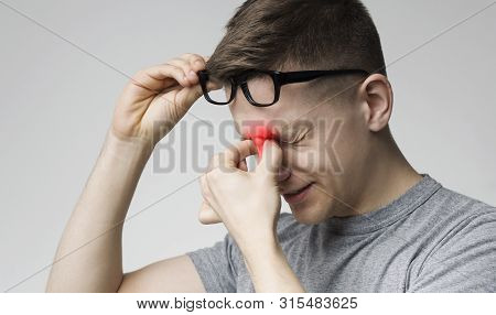 Astigmatism. Tired Man Suffering From Eye Pain, Rubbing Red Sore Nosebridge
