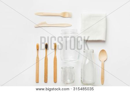 Cotton Washcloth Bamboo Toothbrushes Wooden Cutlery Glass Bottle Jar On White Background. Zero Waste