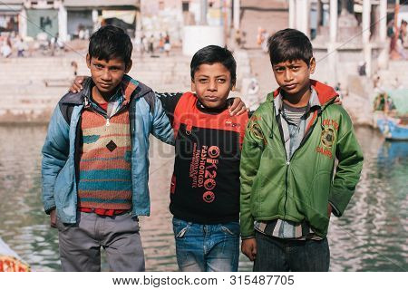 Chitrakoot, India: Three Friendly Boys In Bright Clothing Having Fun On Indian City Street On Decemb