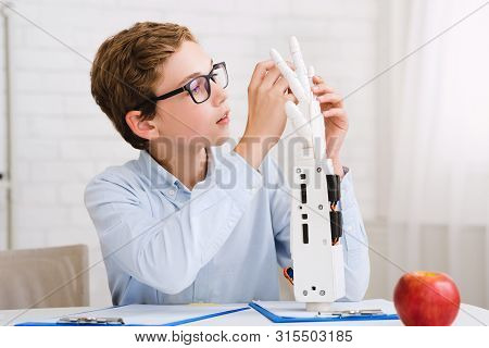 Smart Whizzkid Experimenting With Humanoid Robotic Hand, Developing His Skills At Lesson