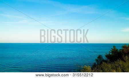 Baltic Sea From Cliff In Mechelinki, Poland. Nature And Travel Concept. Copy Space On Blue Sky.