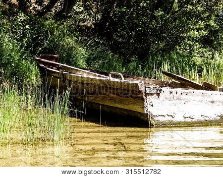 Boat On Wdzydzkie Lake Coast. Old Abandoned Boat On Wdzydze Lake Coast. Wdzydze Landscape Park, Kash