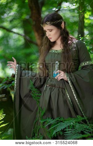 Elf With A Bottle Of Magic Potion In The Forest