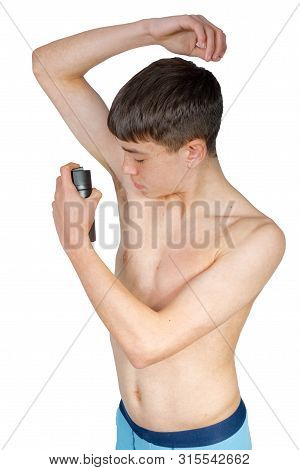Teenage Boy Using An Under Arm Spray Isolated On A White Background
