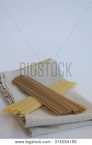 Raw Plain And Wholemeal Spaghetti Togheter On A Cloth