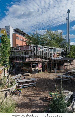 Berlin, Germany - September 26, 2018: Open Space With Wood Benches And A Building With Many Windows 