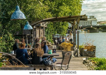 Berlin, Germany - September 26, 2018: Panorama Of Visitors Near Trees Sitting In Wood Benches And En