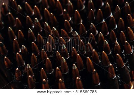 Bullets On A Wooden Background. Military Concept.