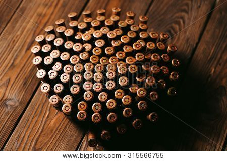 Bullets On A Wooden Background. Military Concept.