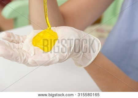 Young Beautiful Girl Shows How To Make Slime. Yellow Homemade Slime Is A Children's Toy. Composition