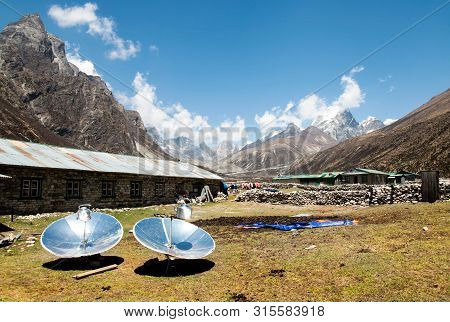 Warming The Teapot In A Solar Cooker. Ecology Concept. Renewable Green Energy. Nepal. Himalaya.