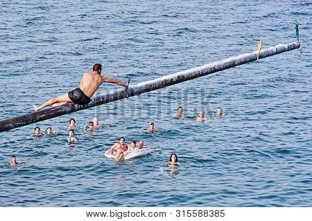 Xghajra, Malta - August 3, 2019: Traditional Maltese Game Of Gostra, Where Is Brave Local Men Would 