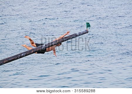 Xghajra, Malta - August 3, 2019: Traditional Maltese Game Of Gostra, Where Is Brave Local Men Would 
