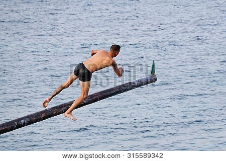 Xghajra, Malta - August 3, 2019: Traditional Maltese Game Of Gostra, Where Is Brave Local Men Would 
