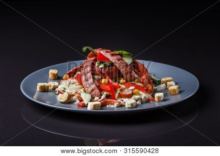 Salad With Grilled Sausage Paprica Cucumber And Croutons