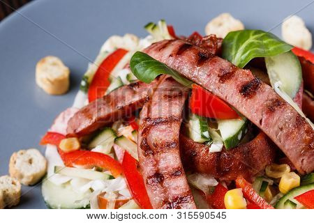 Salad With Grilled Sausage Paprica Cucumber And Croutons