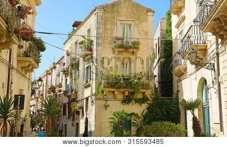 Fancy Cozy Decorated Narrow Street In Ortygia Old Town Of Syracuse In Sicily, Italy