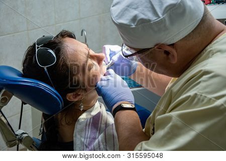 The Dentist Shines A Uv Light Seal To A Woman In A Private Clinic

The Dentist Shines A Uv Light Sea