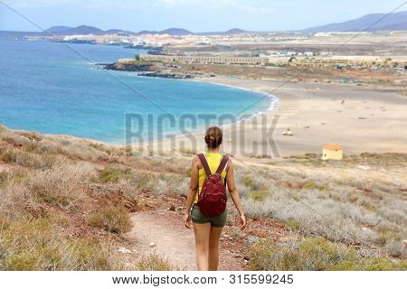 Female Hiker Descent The Pathway With Spectacular Landscape Of Playa La Tejita Beach, Tenerife, Cana