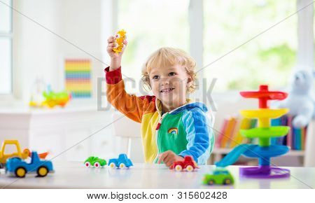 Boy Playing Toy Cars. Kid With Toys. Child And Car