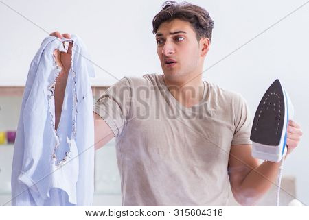 Inattentive husband burning clothing while ironing