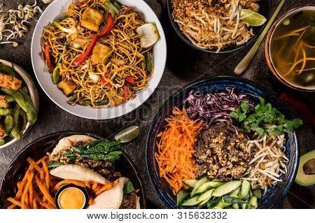 Asian food background with various ingredients on rustic wooden background , top view. Vietnam or Thai cuisine.