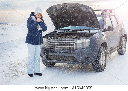 A Woman Near A Broken Car Trying To Fix The Engine. Shes On The Phone. Shes Cold. Around Winter And 