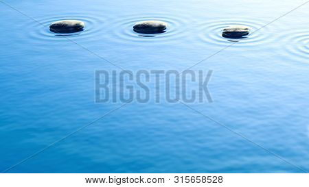 pebble stones in water with ripples background 3D illustration