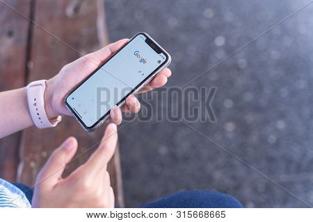Chiang Mai, Thailand - Jul.27,2019: Woman Holding Apple Iphone Xs With Google Apps  For Searching On