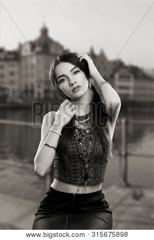 Portrait Of A Girl In A Dress In The Style Of The Sixties - Seventies Sitting Pose In A Studio About