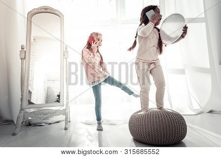 Two Sisters Playing On The Bedroom Floor In The Morning