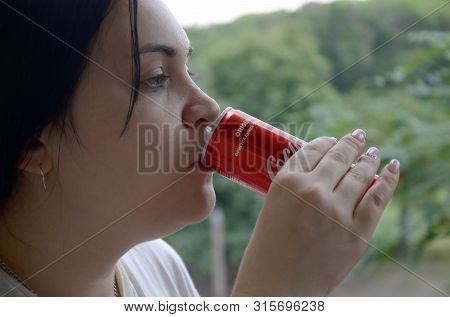 Caucasian Woman Drinking Coca Cola Bottle Red Tin Can 250ml