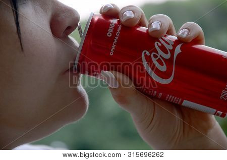Caucasian Woman Drinking Coca Cola Bottle Red Tin Can 250ml
