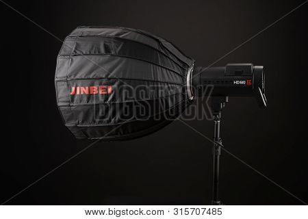 A Modern Electric Saturated Black Octobox On A Tripod. A Huge Octobox Over Black Background. Equipme