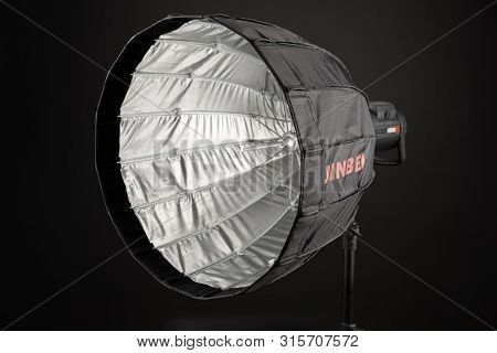 A Modern Electric Saturated Black Octobox On A Tripod. A Huge Octobox Over Black Background. Equipme