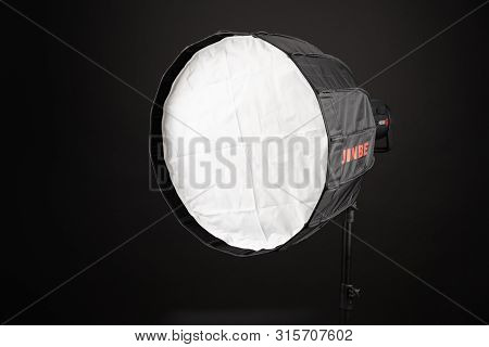 A Modern Electric Saturated Black Octobox On A Tripod. A Huge Octobox Over Black Background. Equipme