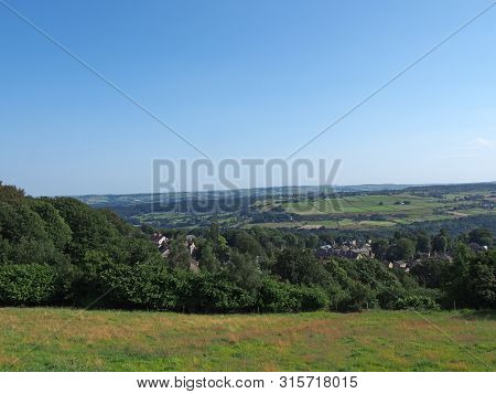 A Panoramic View West Yorkshire Countryside With The Village Of Warley Surrounded By Woodland And Fa