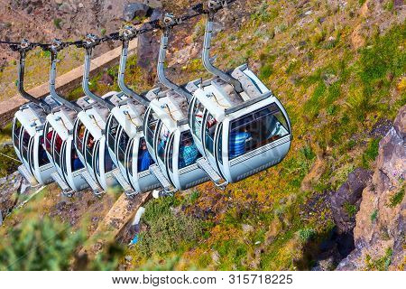 Fira, Santorini Island, Greece Close-up Cable Car Cabins From Old Port, High Volcanic Rocks