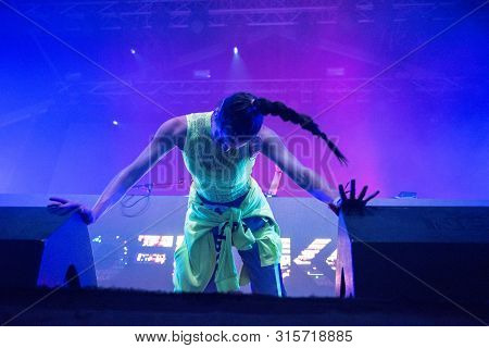 Woman Performer Singing On Stage