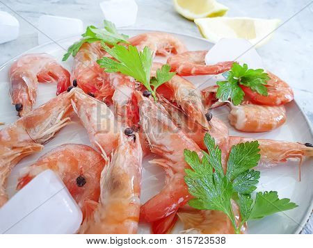 Fresh Shrimp On A Plate, Lemon Ice On A Concrete Background