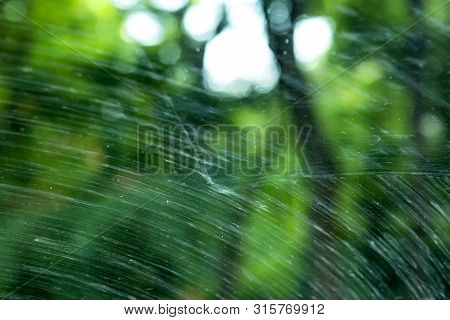 Windshield Of A Dirty Car In Mud Smeared By Car Wipers Close Up.