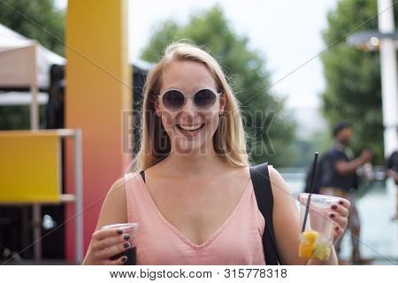 21 July 2018 - London, United Kingdom: Girl Holding Drinks At Music Festival