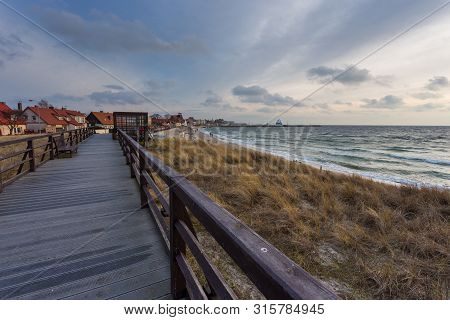 Hel, Poland- 31 January 2015: Wooden Pier On The Dunes At The Beach In The City Of Hel. Town And Bal