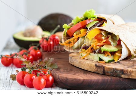 A Healthy Lunch Or Dinner Of A Vegan / Vegetarian Wrap Made With  Argula Lettuce, Sliced Tomatoes, C