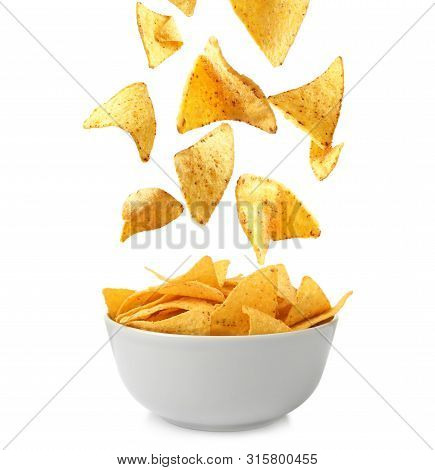 Delicious Mexican Nachos Chips Falling Into Bowl On White Background