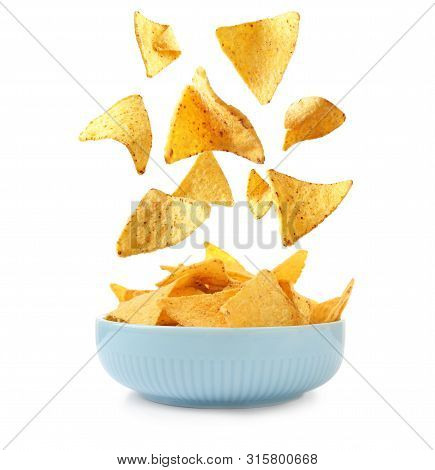 Delicious Mexican Nachos Chips Falling Into Bowl On White Background