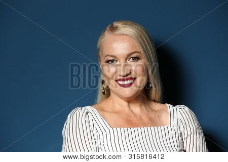 Portrait Of Beautiful Mature Woman On Blue Background