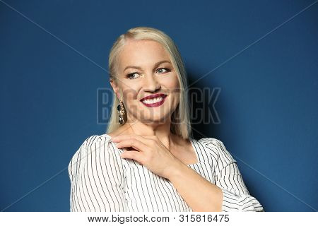 Portrait Of Beautiful Mature Woman On Blue Background