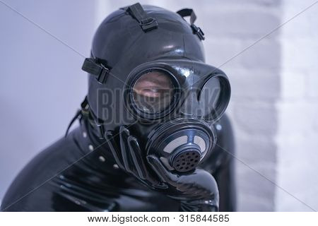 Man In The Latex Rubber Black Catsuit With Gasmask