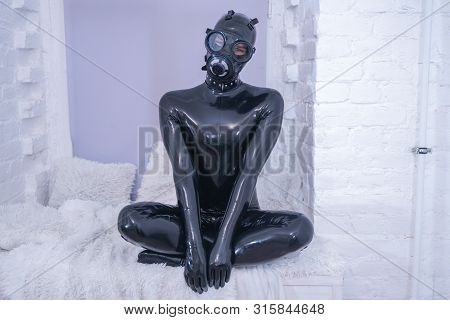 Man In The Latex Rubber Black Catsuit With Gasmask